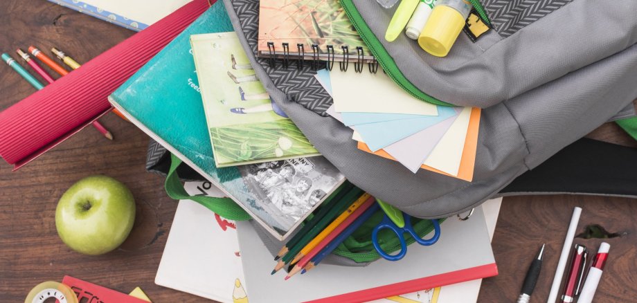 Empty school backpack with books and pens